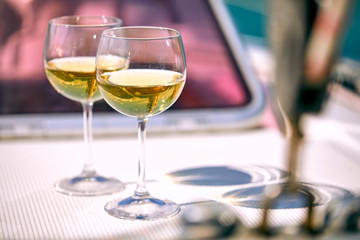 Pair of wineglasses against the yacht
