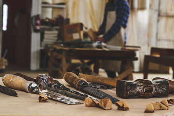 Carpenter tools. Chisel or gouge for wood on carpenter working at workbench. Carpentry workshop