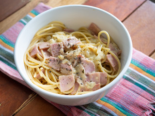 pork ham Carbonara pasta spaghetti seasoning with black pepper on fabric mat