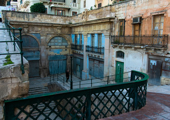 Man climbing up the stairs in Valletta, Malta