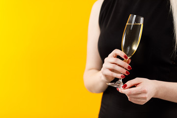 Beautiful sexy blonde girl holding in hands bottle of champange and wineglasses with champagne. Party girl. Celebrating.