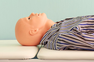 Medical training mannequin lying horizontally half-face