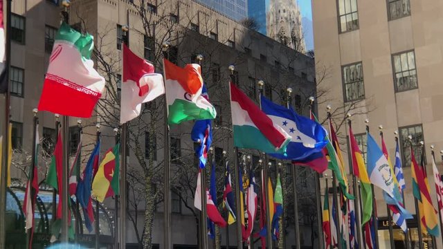 International flags from around the world.
Pan  line of flags blowing in breeze.
Slow Motion.
Lens flare.