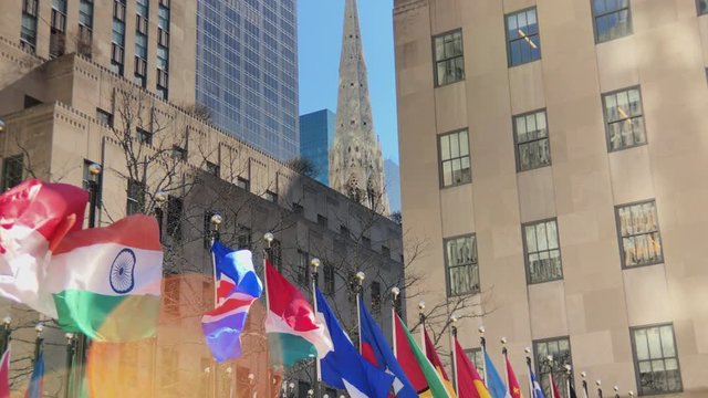 International flags from around the world.
Pan down to line of flags blowing in breeze.
Slow Motion.
Lens flare.