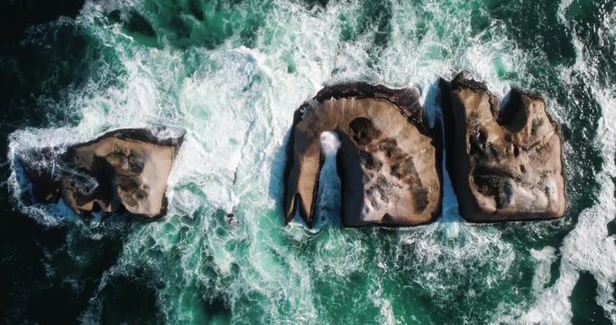 A moody scene of Waves crashing over rocks in the ocean.  Filmed 50FPS 4K 4096 x 2160 Delivered 25FPS 4096 x 2160 - Slowed down from the 50FPS Original.
