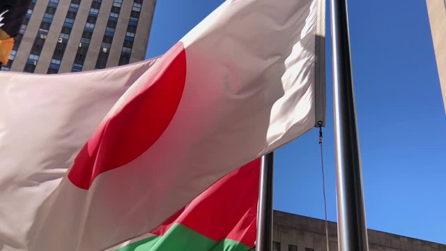 International flags from around the world.
Slow motion close up of Japanese flag blowing in the breeze.