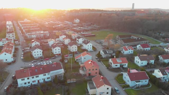 Aerial video of a nice suburban area at sunrise or sunset with a footballfield in the background in Orgryte, Gothenburg, Sweden