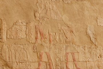 Ancient egyptian paintings and hieroglyphs on a wall in Mortuary temple of Hatshepsut in Luxor, Egypt