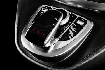 Media and navigation control buttons of a Modern car. Car interior details. Brown leather interior...