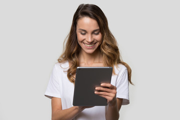Fototapeta premium Woman using gadget looking at digital tablet screen studio shot