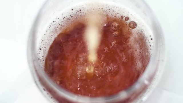 Slow Motion shot of Serving Beer in a glass