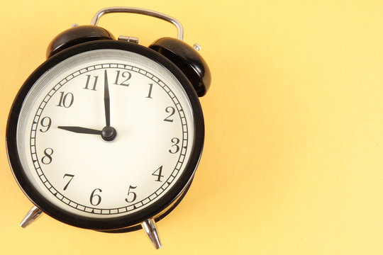 Time Punctuality Concept with black alarm clock.
