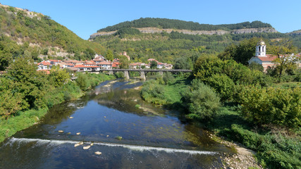 Fototapeta na wymiar Assenova Masahal district Veliko Tarnovo Bulgaria. Bishops bridge over the river Yantra and the medieval area of VT