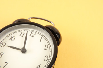 Time Punctuality Concept with black vintage alarm clock.