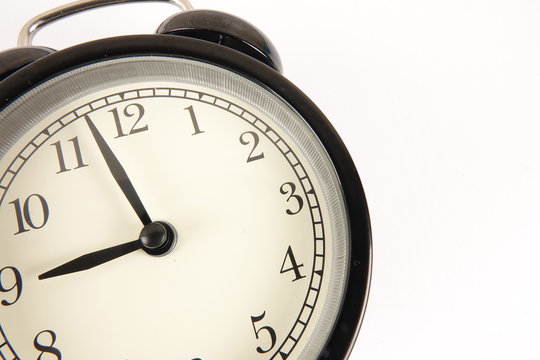 Time Punctuality Concept with black vintage alarm clock.