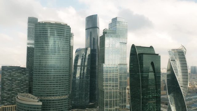 Aerial rising shot of modern skyscrapers within cityscape of Moscow, Russia