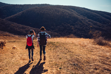 Mother and daughter hiking on mountain trail