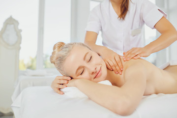 Fototapeta na wymiar Body massage. Woman in the massage parlor.