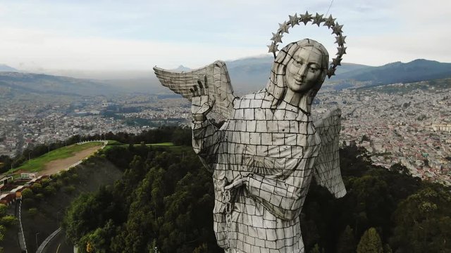 Orbital aerial medium shot around Virgin Mary statue in South America, Quito city