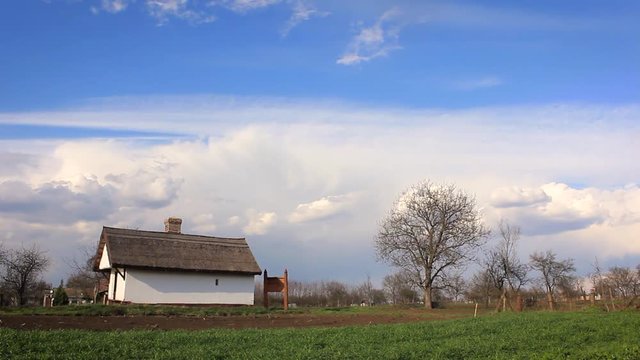 Old building in the countryside of Hungary. Bright, sunny day with some clouds on the sky.