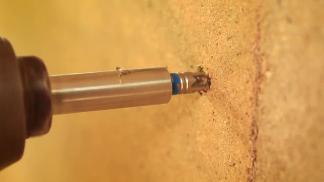 Drill drills a nail into the cork.