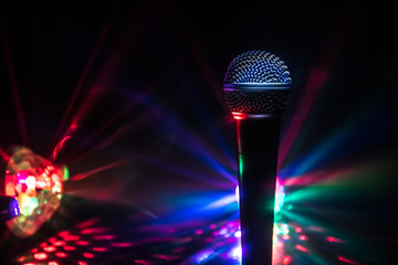 Microphone karaoke, concert . Vocal audio mic in low light with blurred background. Live music,...