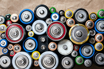 Used Alkaline batteries on recycled paper toxic waste recycling and ecology issues concept...