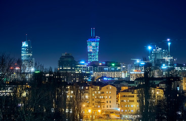 Beautiful, amazing panoramic view of Warsaw (Poland) with skyscrapers and a Palace of Culture and Science during spring flowering at night