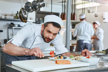 We know how to cook. Chef cook preparing japanese food in modern commerical kitchen