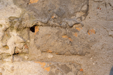 Old demolished concrete wall with bricks. Texture of concrete and brick wall.