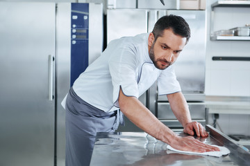 When preparing foods keep it clean, a dirty area should not be seen. Young male professional cook...