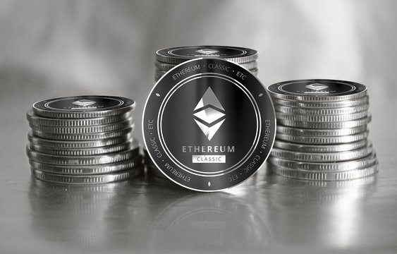 Ethereum Classic (ETC) digital crypto currency. Stack of black and silver coins. Cyber money.