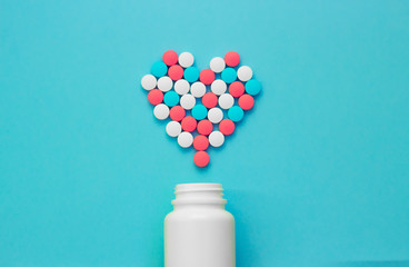 Heart of pills on a blue background