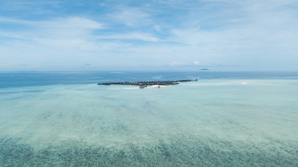 resort over a reef surrounded by clear water