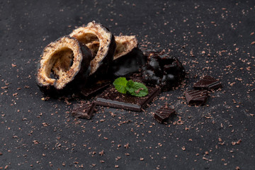 pieces of chocolate cake and chocolate on a dark table