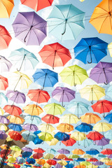 Multi-colored umbrellas against the sky