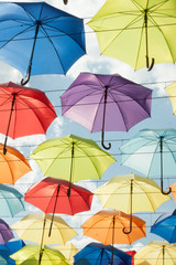 Fototapeta na wymiar Multi-colored umbrellas against the sky