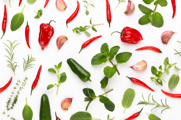 Spice herbal leaves and chili pepper on white background. Vegetables pattern. Floral and vegetables on white background. Top view, flat lay.