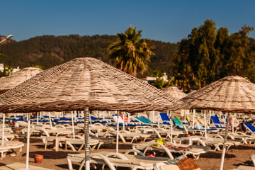 large wicker bamboo umbrellas on the beach. Turkey, Marmaris