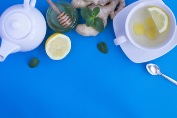 Ginger tea and ingredients on the blue background.Top view.Copy space.