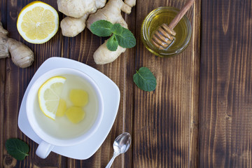 Ginger tea and ingredients on the brown background.Top view.Copy space.