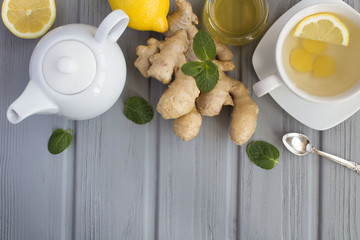 Ginger tea and ingredients on the  grey wooden  background.Top view.Copy space.