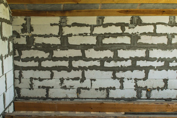 Texture of a large silicate brick, framed by boards close-up