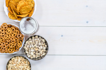 Beer and snacks on wooden background. Empty space for text