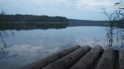 Pier on a lake in the woods in the evening.