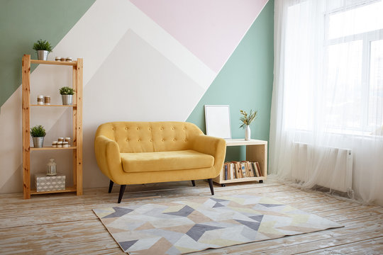 Nice Living Room With Couch, Carpet, Green Plant On A Bookcase.