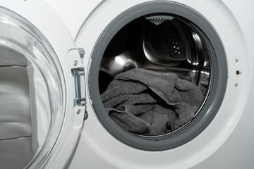 Clean gray cotton towel just washed in an automatic washing machine