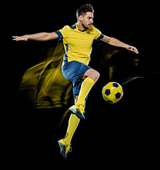 one caucasian soccer player man isolated on black background with light painting speed effect