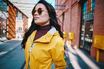 Obraz premium Female fashion concept. Close up. Colorful detail of yellow coat . Street style