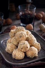 Snack cheese balls with prunes and walnuts, selective focus